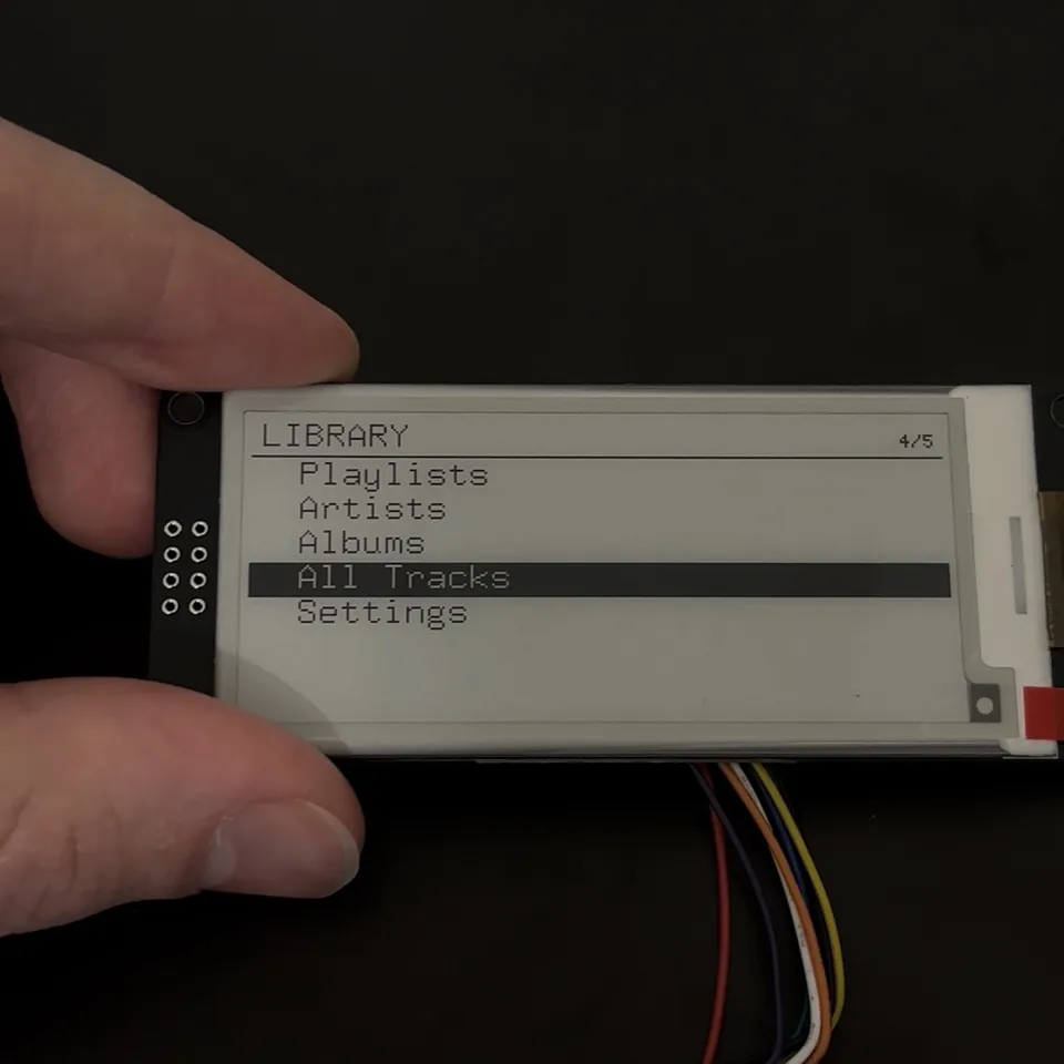 MusicStation V2 e-paper display showing the library menu on wired hardware